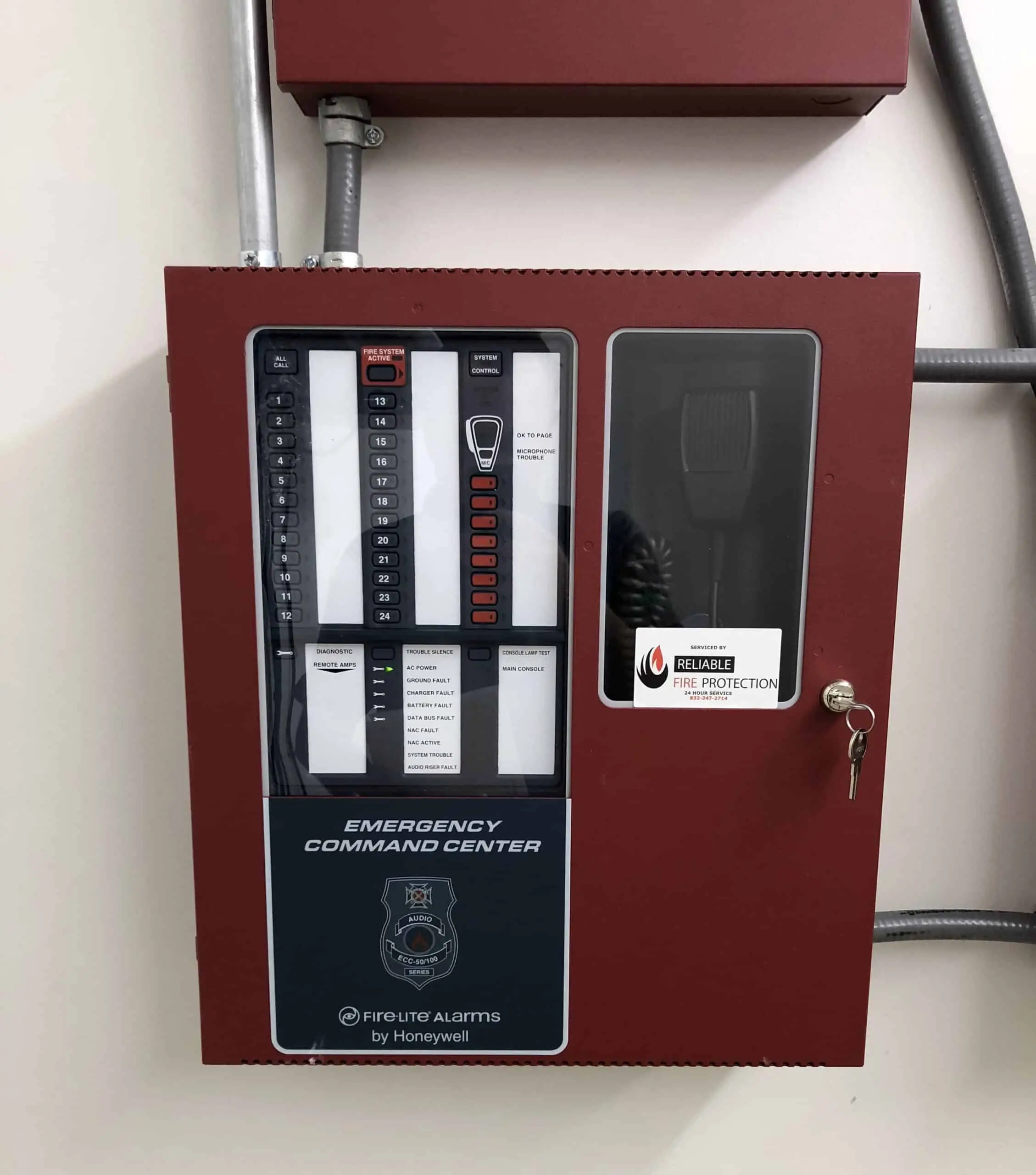 Fire alarm emergency command center control panel with Honeywell branding, featuring operational buttons and indicators, installed by Reliable Fire Protection.