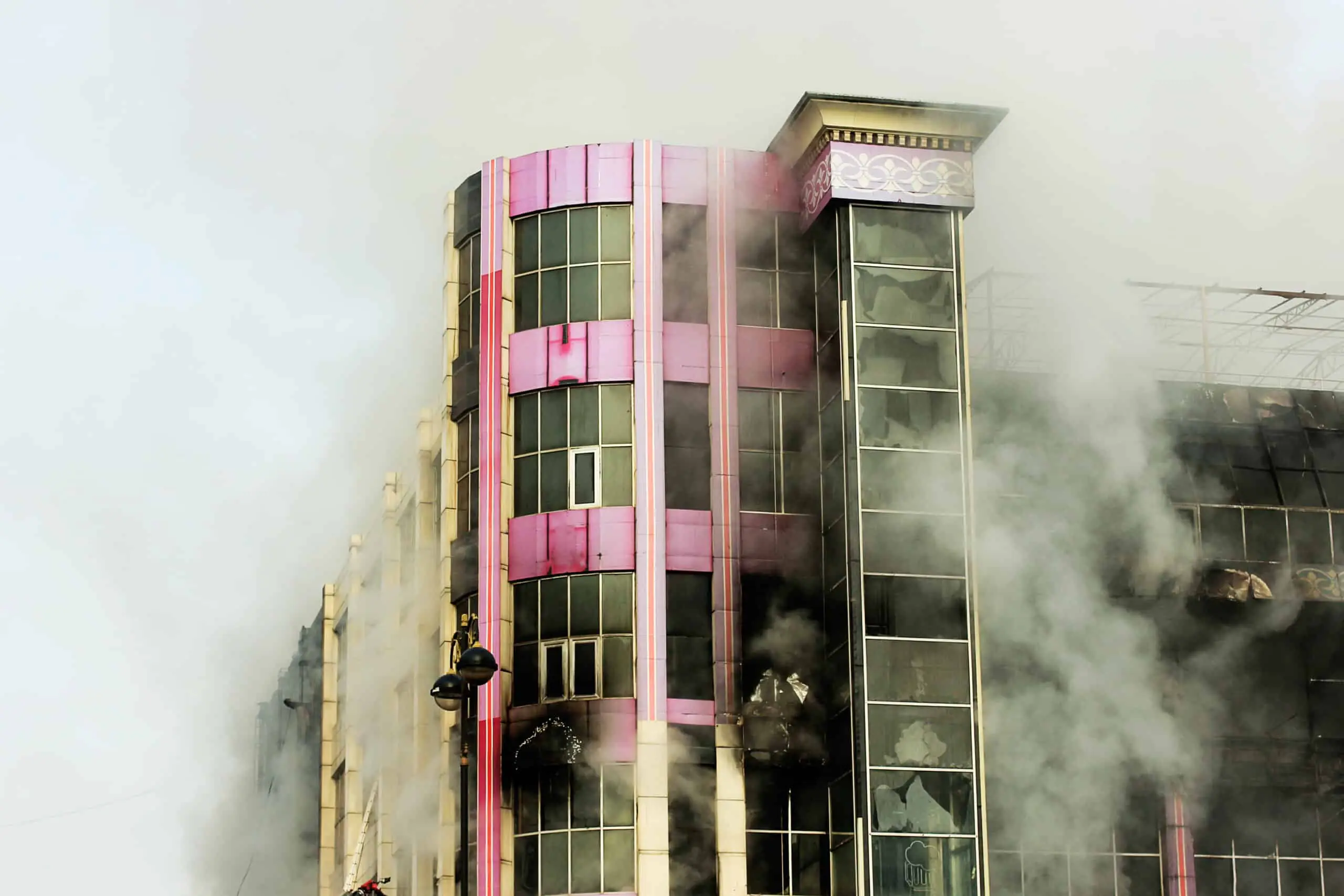 Smoke pouring from a burning multi-story shopping center