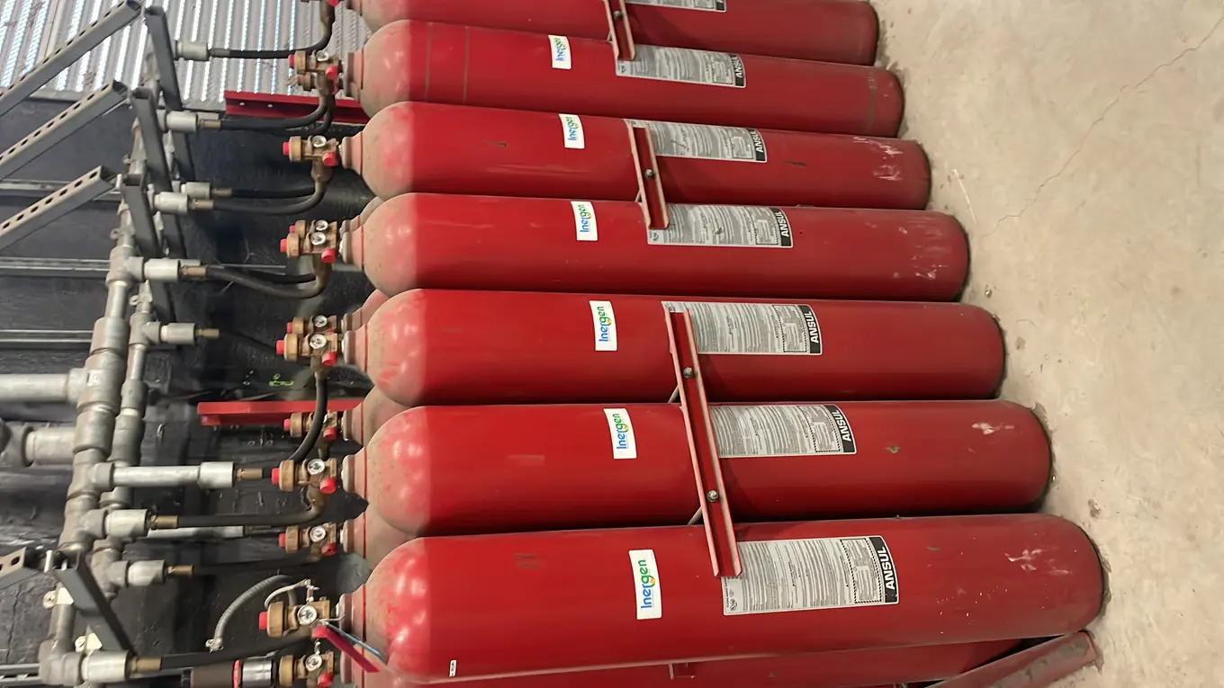 Row of clean agent fire suppression cylinders in an equipment room
