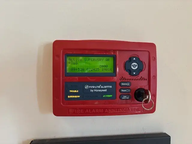 Fire-Lite fire alarm annunciator showing a supervisory signal during an inspection
