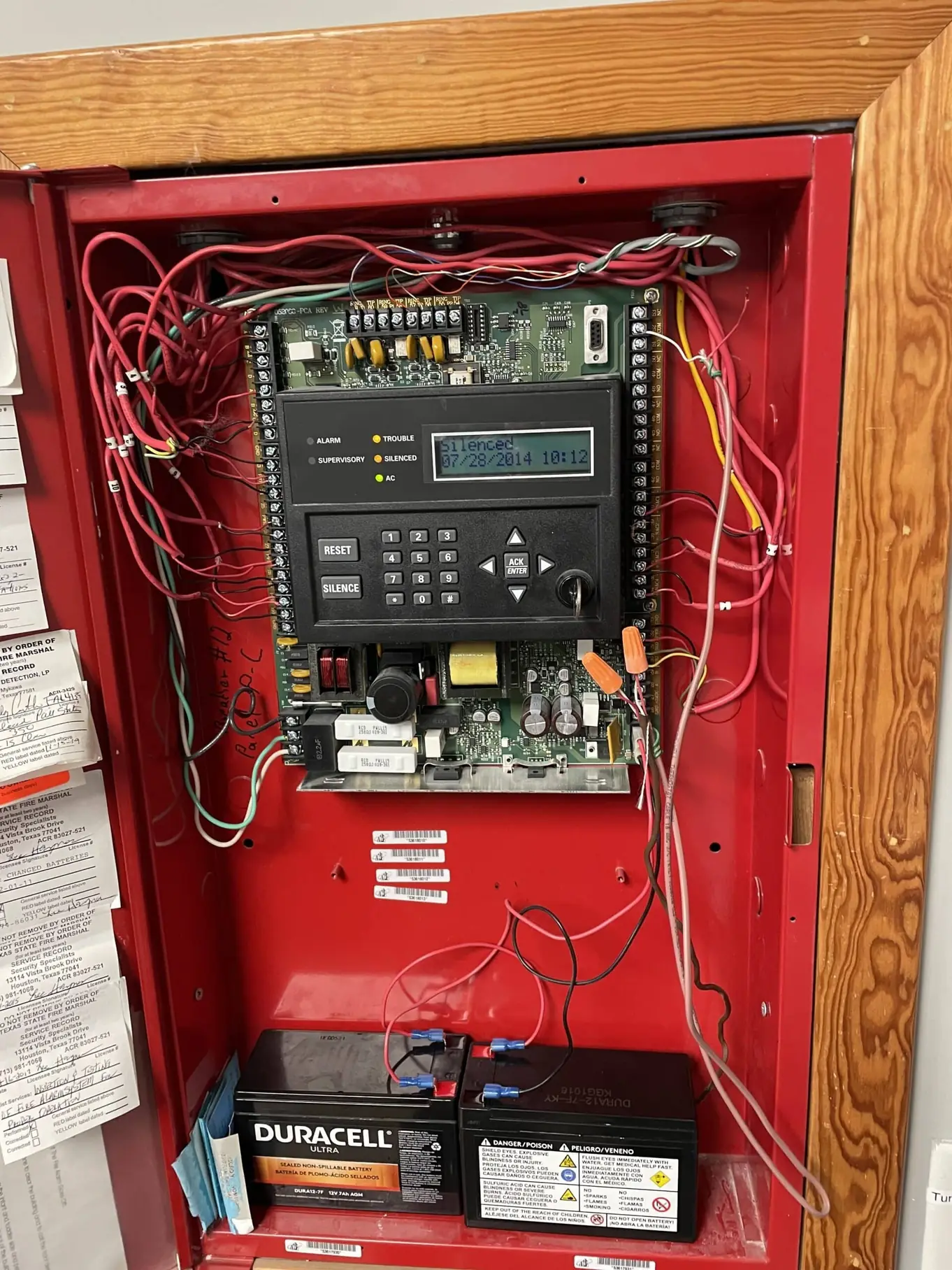 Fire alarm control panel with its keypad, wiring and backup batteries