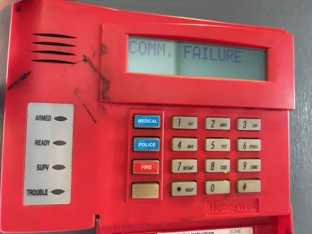 Honeywell fire alarm keypad showing a communication failure