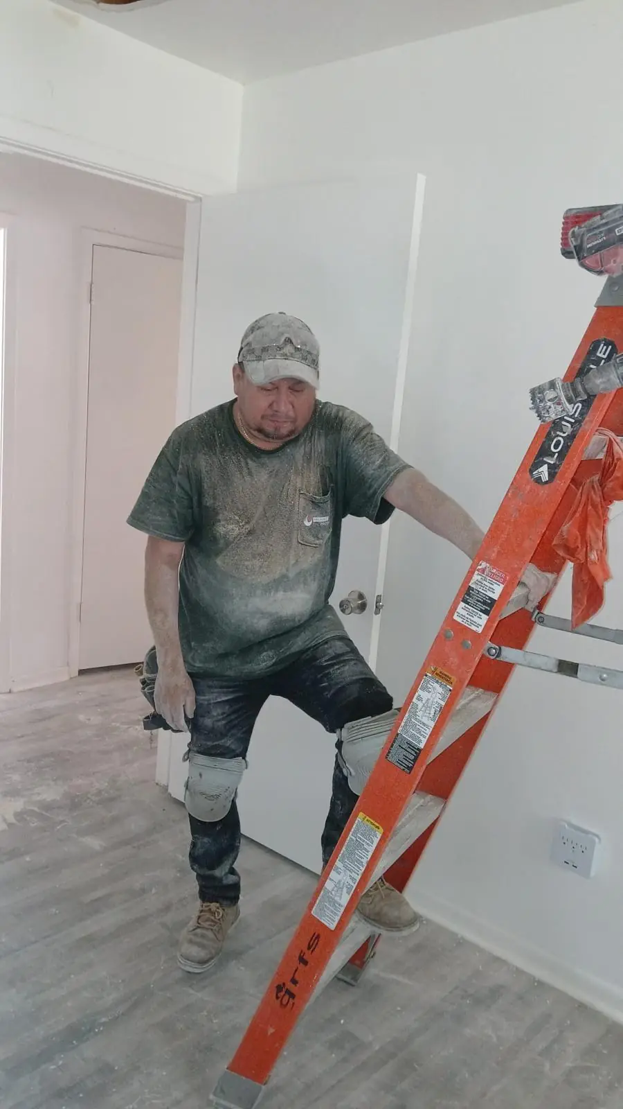 Reliable Fire Protection technician on a ladder at a job site