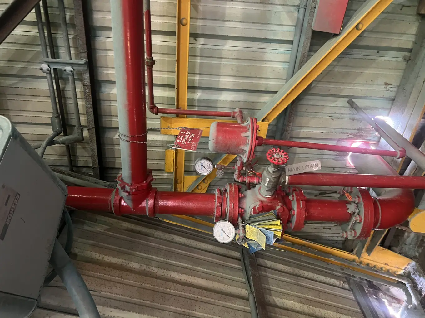 Fire sprinkler riser with gauges in an industrial building