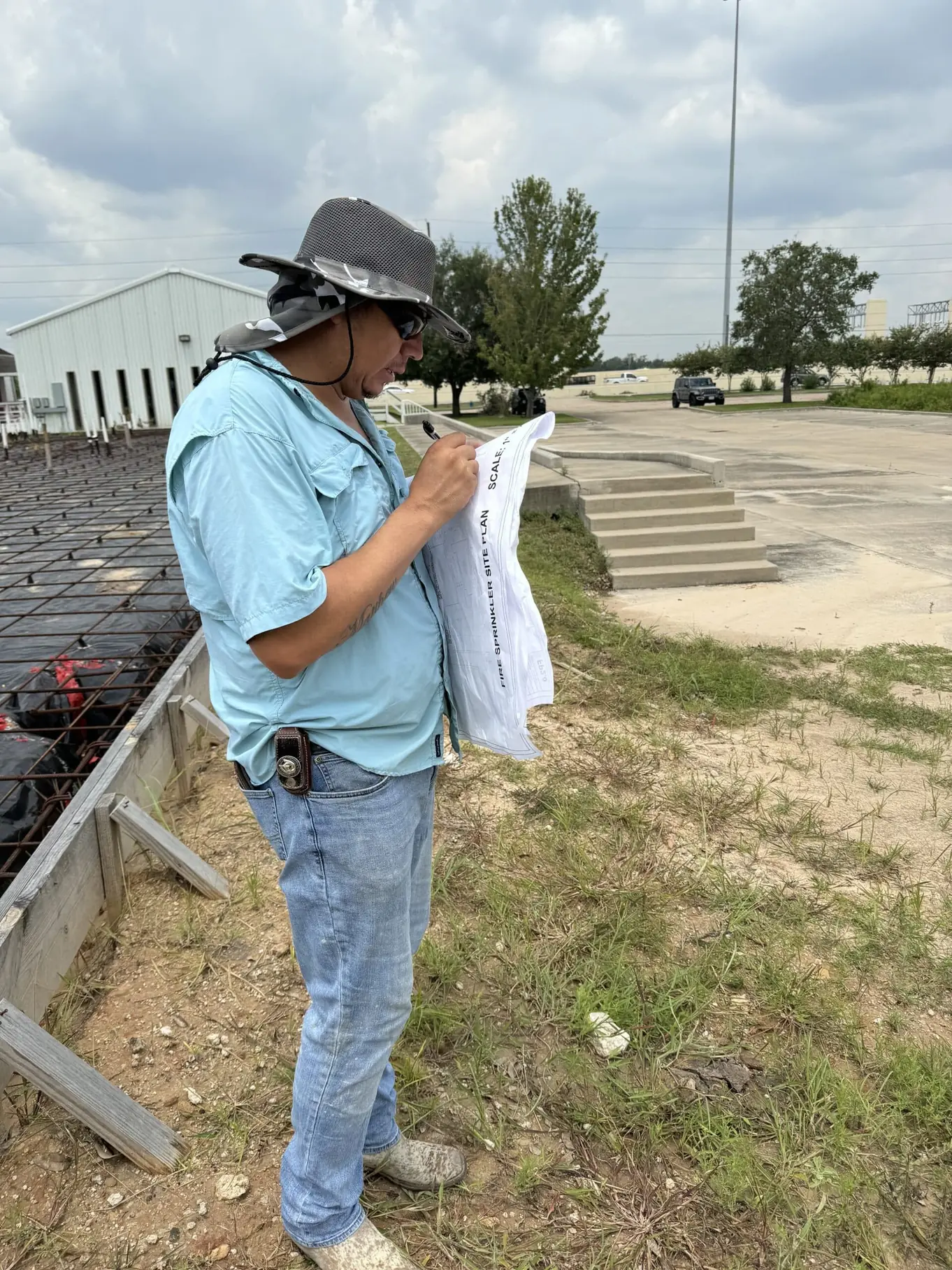 Reliable Fire Protection technician reviewing fire protection plans on a job site