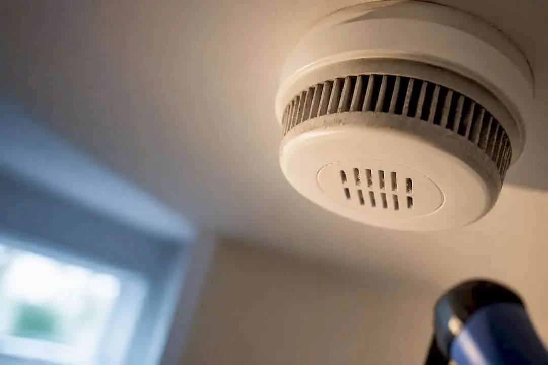 Close-up of an aging ceiling smoke alarm