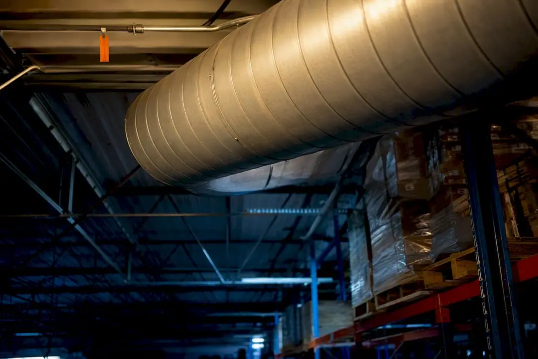 High-bay warehouse with sprinkler piping above storage racks
